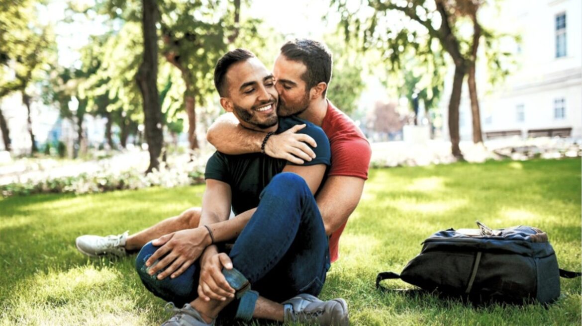 Gay Couple A gay couple embracing on a lawn.